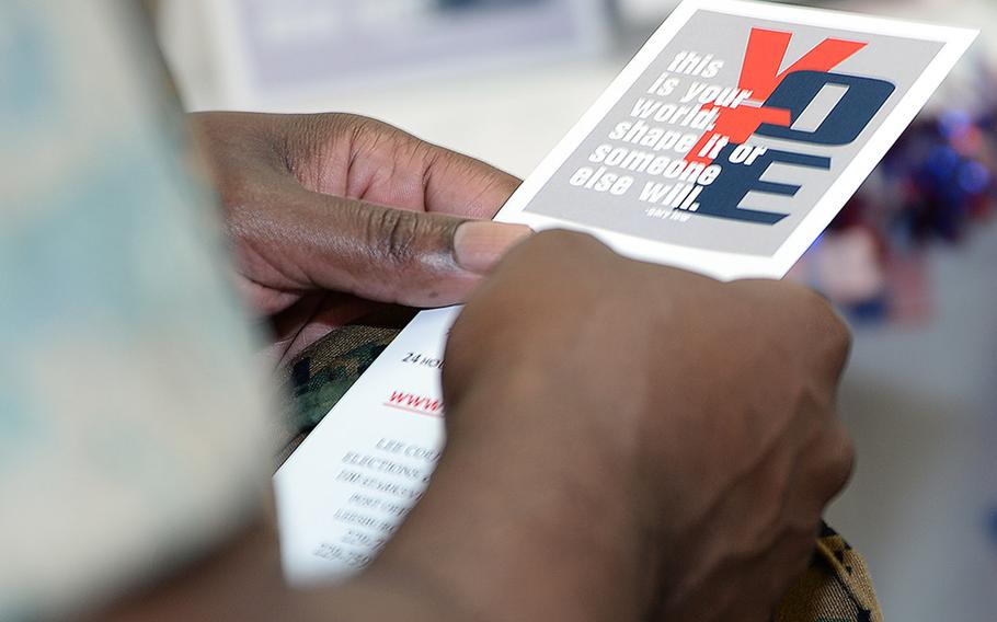 A Marine voter reads voting literature during the Marine Corps Logistics Base Albany's first voting convention, June 22, 2017.