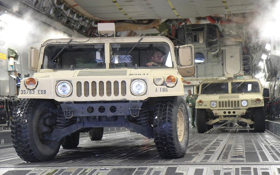 Soldiers assigned to C Company, 63rd Expeditionary Signal Battalion, 35th Theater Tactical Signal Brigade move vehicles and equipment onto a C-17 Globemaster III at Hunter Army Airfield in Georgia before their relief deployment to Texas in support of Hurricane Harvey.