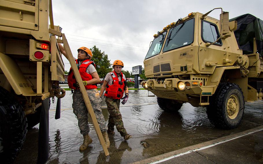 Soldiers with the Texas Army National Guard ready their trucks as they make their way through Houston while floodwaters from Hurricane Harvey continue to rise, Monday, Aug. 28, 2017. 