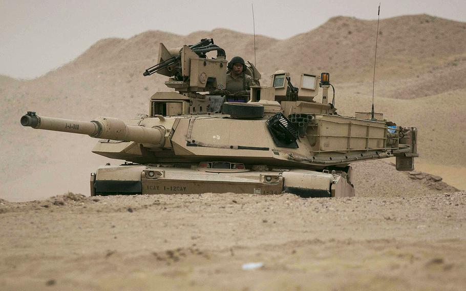 An M1A2 Abrams Main Battle Tank assigned to Alpha Company, 1st Battalion, 12th Cavalry Regiment, 3rd Armored Brigade Combat Team, 1st Cavalry Division maneuvers to the final objective during the company's situational training exercise in Kuwait, July 15, 2017.
