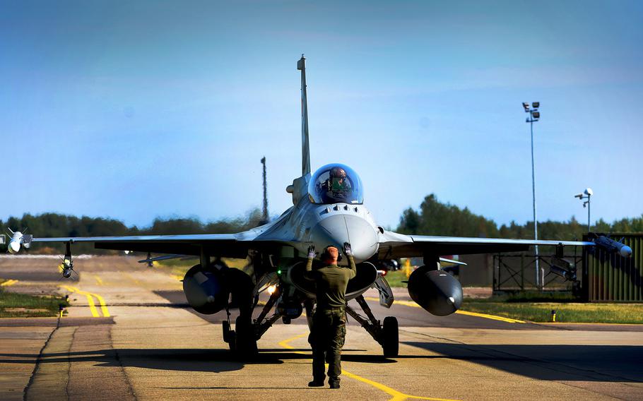 A Polish F-16 pilot taxis after completion of a Baltic Air Policing sortie at Siauliai Air Base, Lithuania, on Wednesday, Aug. 30, 2017. 

