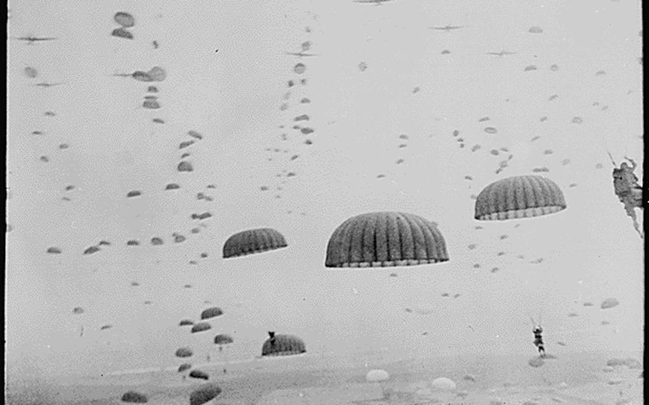 Parachutes open overhead as waves of paratroops land in Holland during operations by the 1st Allied Airborne Army on Sept. 17, 1944.