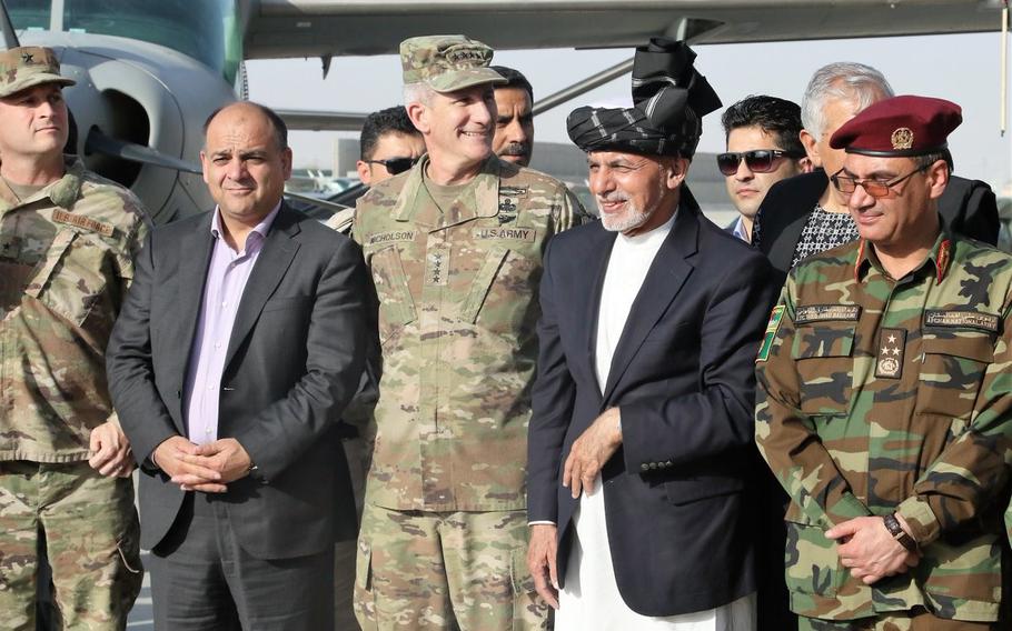 Gen. John Nicholson, commanding general of Resolute Support Mission, stands next to Afghan President Ashraf Ghani, center right, during a ceremony in Kandahar on Saturday, Oct. 7, 2017, as the United States presented two Black Hawk helicopters to the Afghan military.