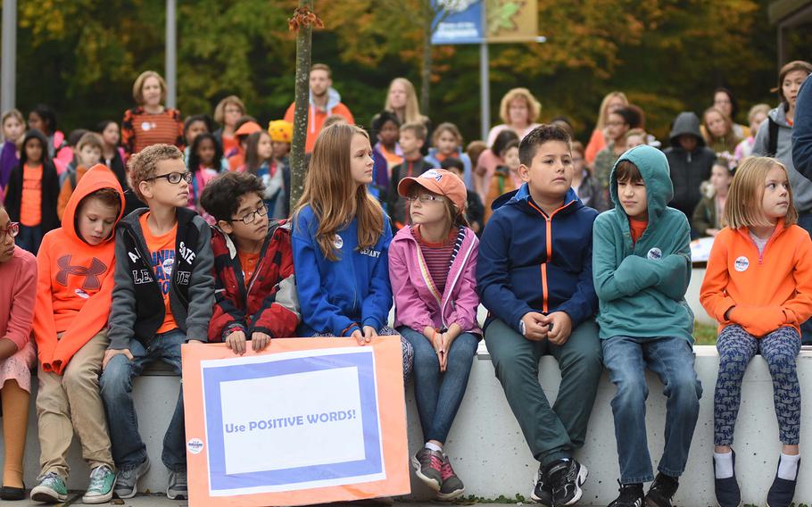Students at Ramstein Intermediate School in Germany hold a plaque reading "Use Positive Words!" while participating in the school's Unity Day celebration on Wednesday, Oct. 18, 2017. Many students wore orange, the color typically worn on Unity Day, to symbolize inclusion, acceptance and kindness.