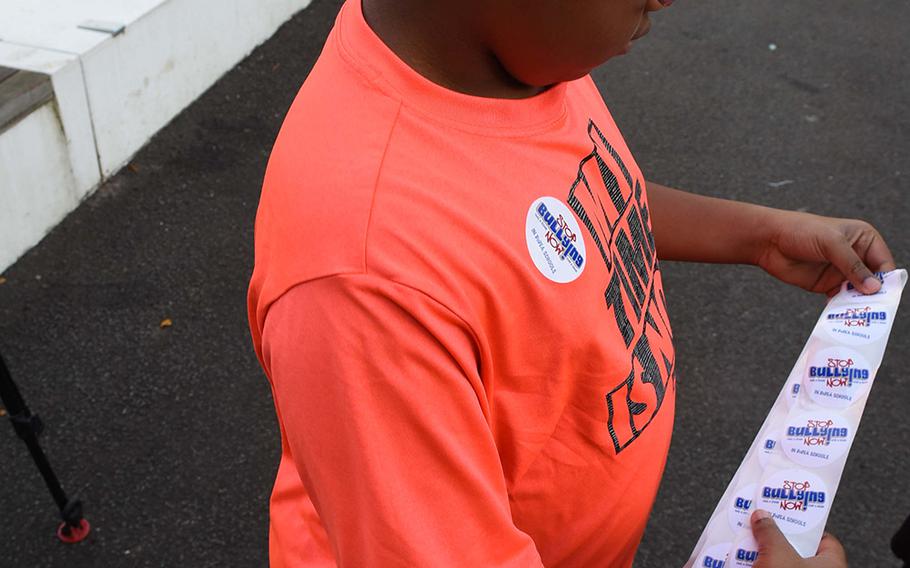 Josiah Williams, a fifth-grader at Ramstein Intermediate School in Germany, prepares to hand out "Stop Bullying Now" stickers during the school's celebration of Unity Day on Oct. 18, 2017. 

