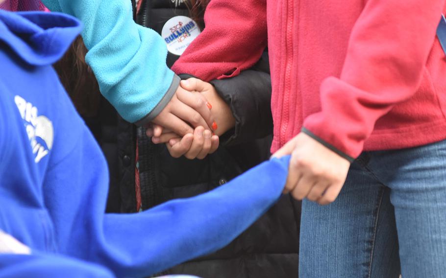 Students at Ramstein Intermediate School in Germany hold hands to show their support for one another during the school's celebration of Unity Day on Oct. 18, 2017. The event was part of the school's annual bullying-prevention campaign.

