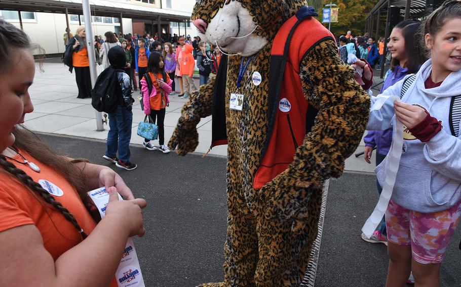 Ramstein Intermediate School fifth-graders Lucy Baxter, left, and Britain Gonzales put "Stop Bullying Now" stickers on the school's mascot during the school's celebration of Unity Day on Wednesday, Oct. 18, 2017, in Germany. 

