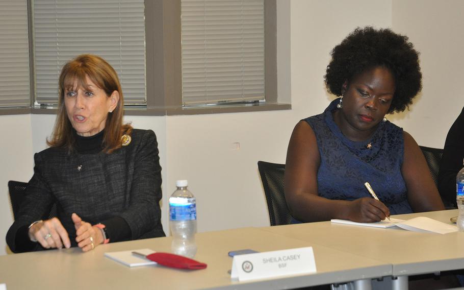 Sheila Casey, COO of the publication The Hill and chair of the board at Blue Star Families, speaks during a summit on military spouse unempoloyment on Oct. 23 in Arlington, VA. To her right, military spouse and caregiver Patricia Ochan, a lawyer with a masters in cyber security, takes notes.