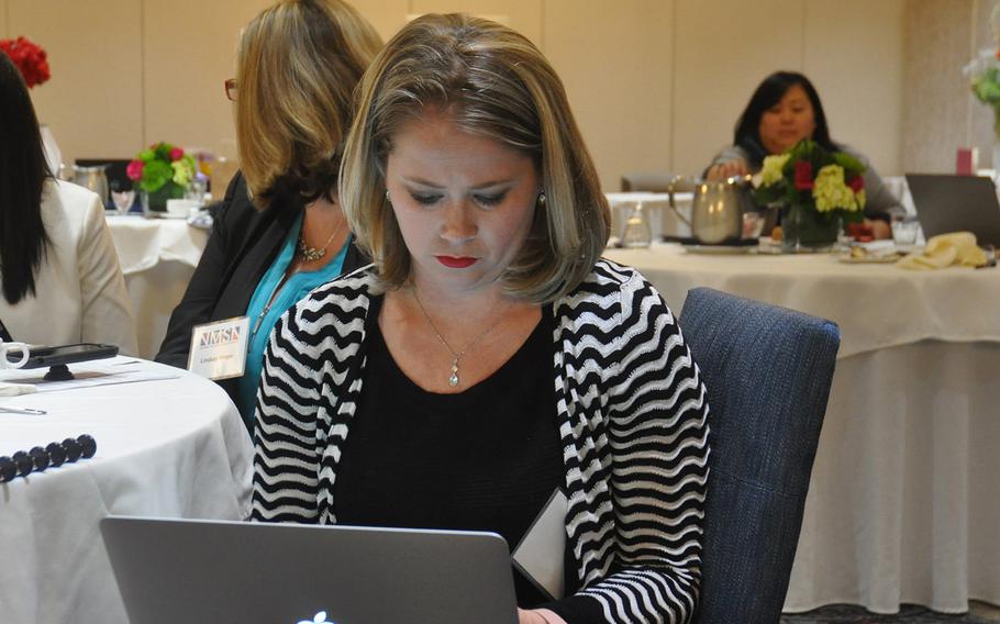 Cyndi Meadows, a graphic artist and virtual assistant who is married to a Navy Explosive Ordnance Disposal technician, takes notes during a business development conference for military spouses on Oct. 13 in Springfield, VA.