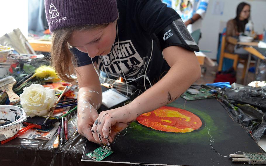 Alconbury's Mary McLellan adds some wire to one of her works in the mixed media class at DODEA-Europe's Creative Connections, Wednesday, Nov. 1, 2017.

