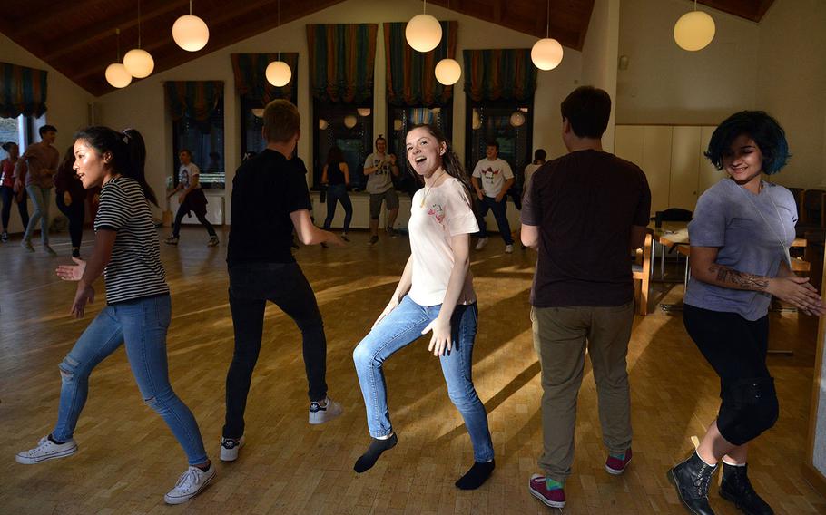 Members of the show choir workshop rehearse the finale of their performance at DODEA-Europe's Creative Connections, Wednesday, Nov. 1, 2017.

