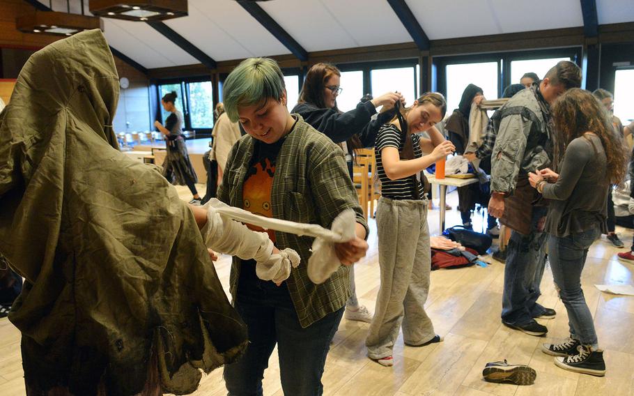 Lakenheath's Julianna Hamill, second from left, and other members of the costume design workshop fit the costumes of the show choir before that group's dress rehearsal at DODEA-Europe's Creative Connections, Wednesday, Nov. 1, 2017.

