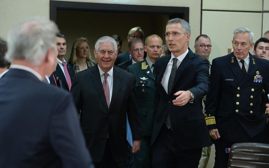 U.S. Secretary of State Rex Tillerson arrives in the meeting room with NATO Secretary General Jens Stoltenberg on Dec. 5, 2017.