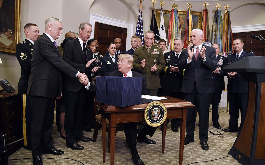 President Donald Trump shakes hands with Secretary of Defense Jim Mattis after signing H.R. 2810, the National Defense Authorization Act for Fiscal Year 2018 on Tuesday, Dec. 12, 2017 in the Roosevelt Room of the White House in Washington, D.C. 