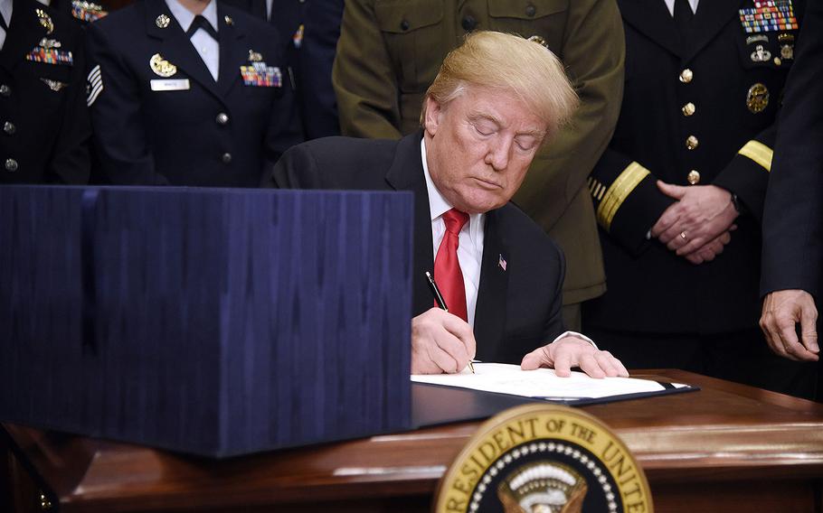 President Donald Trump signs H.R. 2810, the National Defense Authorization Act for Fiscal Year 2018, on Tuesday, Dec. 12, 2017 in the Roosevelt Room of the White House in Washington, D.C. 
