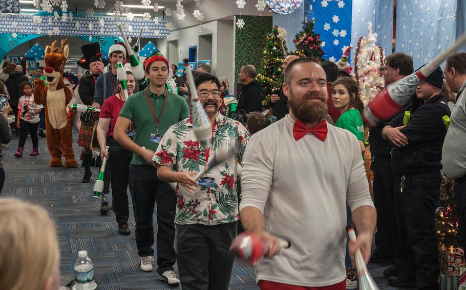 A troup of jugglers put on a show for passengers deplaning from United Airlines' Fantasy Flight after arriving at the "North Pole" at Washington-Dulles International Airport in Virginia on Saturday, Dec. 9, 2017.