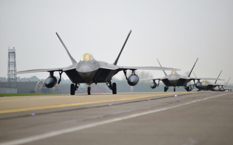 U.S. Air Force F-22 Raptors of the 1st Fighter Wing taxi towards the flight line before take-off at RAF Lakenheath, England, October 19, 2017.