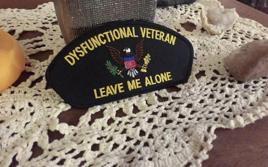 A "dysfunctional veteran" badge sits on top of a hutch in the living room of Dolly Murphy, an Army veteran who was diagnosed with post-traumatic stress disorder following her seven-year military service. After treatment at the National Center for Veterans Studies, she no longer meets the criteria for PTSD.