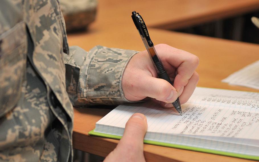 A senior airman takes notes during an enlisted performance report writing course at RAF Mildenhall on July 17, 2012. The Air Force is throwing out performance evaluations for airman of the ranks first class and below, the service announced on Jan. 4, 2018.
