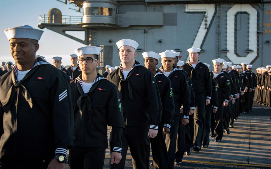 Sailors aboard aircraft carrier USS Carl Vinson prepare to man the rails as the ship departs its homeport of San Diego.