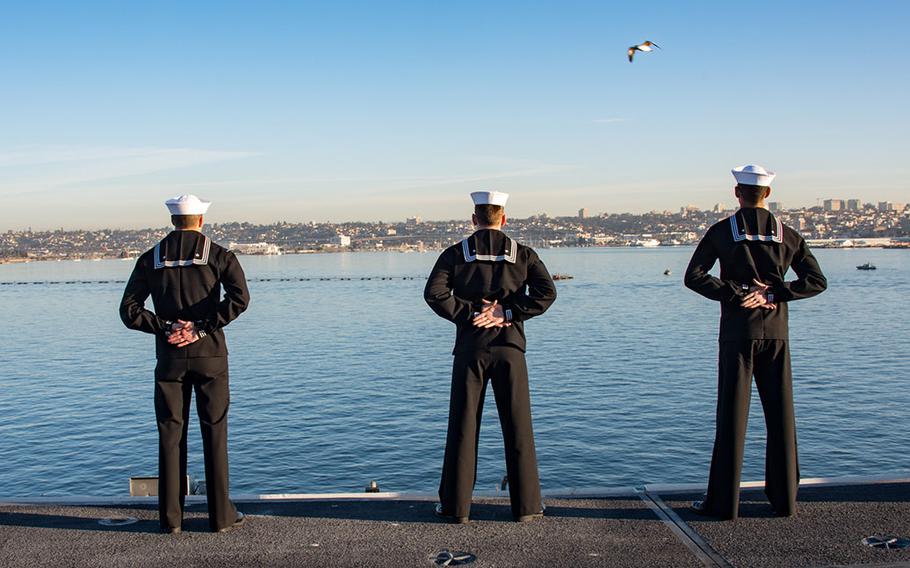 Sailors aboard aircraft carrier USS Carl Vinson man the rails as the ship departs its homeport of San Diego.