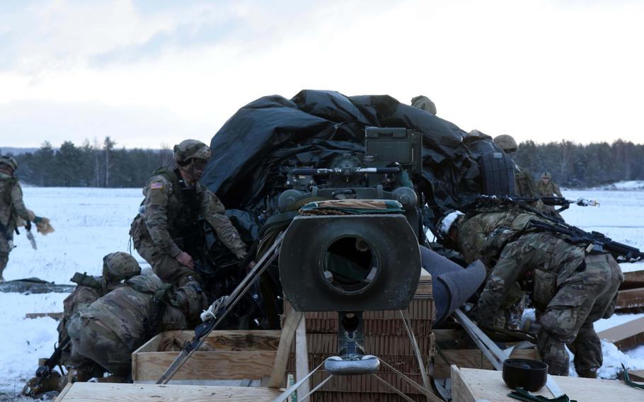 Soldiers with the 173rd Brigade Combat Team (Airborne) assemble an M777 155mm Howitzer that parachuted to the ground during an exercise at Grafenwoehr, Germany, on Wednesday, Jan. 17, 2018. 
