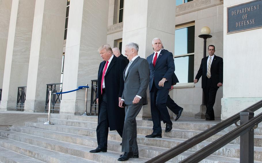 President Donald Trump walks with Defense Secretary James N. Mattis following a meeting at the Pentagon in Washington, D.C., Thursday, Jan. 18, 2018. Vice President Mike Pence looks on from behind.