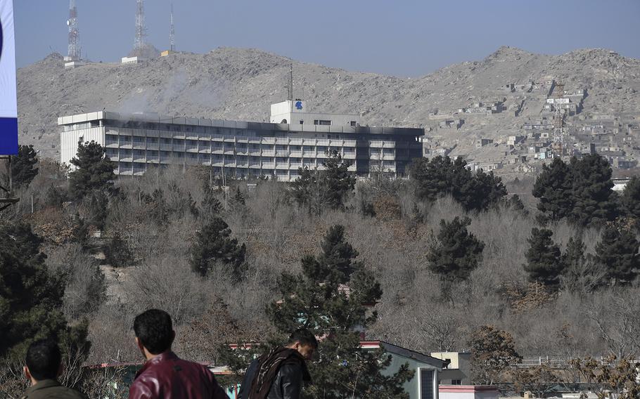 Smoke billows out of the top floor of the Intercontinental Hotel in Kabul, Afghanistan, on Sunday, Jan. 21, 2018. Taliban gunmen stormed the hotel Saturday night, leading to a standoff with Afghan security forces that lasted into the afternoon Sunday, with gunfire and blasts echoing down from the hilltop luxury hotel to where crowds had gathered to watch the siege play out.

Chad Garland/Stars and Stripes
