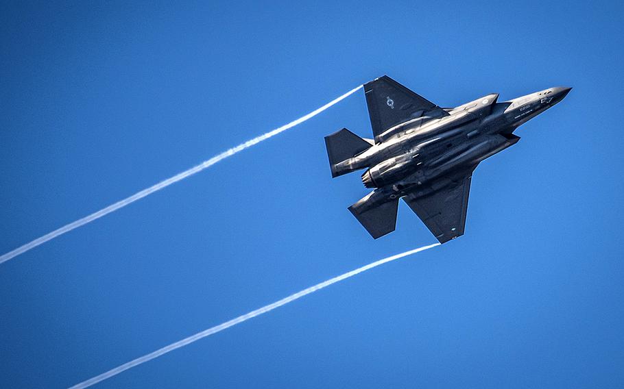 An F-35 Lightning II streaks across the sky while doing maneuvers over the Eglin Air Force Base, Fla., runway.