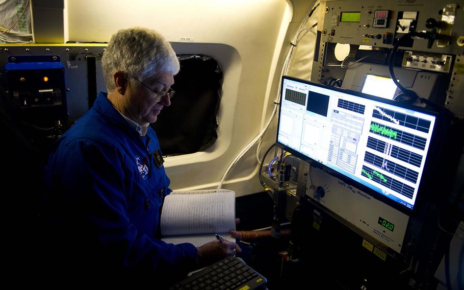 Research scientist Eddie Winstead annotates data during pre-flight checks on NASA's DC-8 Airborne Science Laboratory at Ramstein Air Base, Germany, on Wednesday, Jan. 24, 2018.

