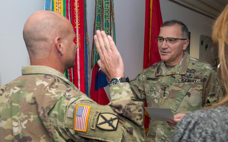 Gen. Curtis M. Scaparrotti, right, reads the oath to defend the U.S. Constitution to Lt. Gen. Christopher G. Cavoli during a promotion ceremony in Wiesbaden, Germany on Jan. 18, 2018.