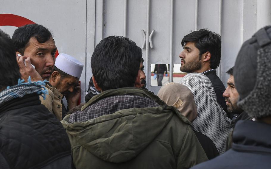 Men and women crowd the gates of Emergency hospital in Kabul, Afghanistan, on Saturday, Jan. 27, 2018, seeking news of loved ones after a deadly ambulance-borne bomb blast earlier in the day. Casualties from the blast strained the hospital's capacity as they arrived in piles in the back of ambulances.

