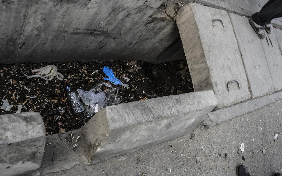 Latex gloves litter the trash-strewn gutters outside Emergency hospital in Kabul, Afghanistan, on Saturday, Jan. 27, 2018, following a deadly attack in the busy center of the city that killed at least 60 people and wounded more than 150 others earlier in the day.