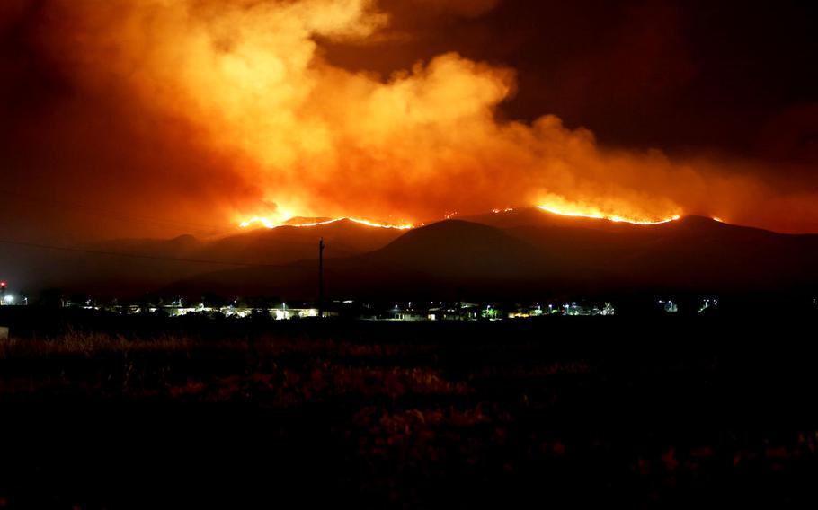 The Tomahawk wildfire burns through the night near Marine Corps Base Camp Pendleton, Calif., May 15, 2014. More than half of 3,500 Defense Department properties experienced climate-related damage in 2014-15, according to a DOD survey sent to Congress Friday.