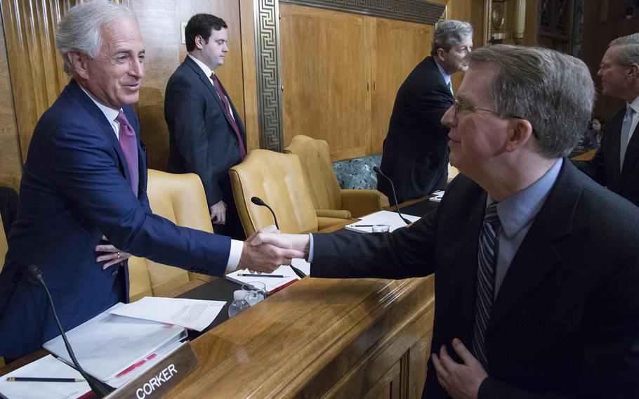 Sen. Bob Corker, R-Tenn., shakes hands with Pentagon Comptroller David L. Norquist before a Senate Budget Committee hearing on Capitol Hill, March 7, 2018.
