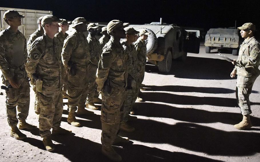 In a September, 2017 file photo, U.S. Army military police and U.S. Air Force security forces report for their night shift at Nigerien Air Base in Agadez, Niger.