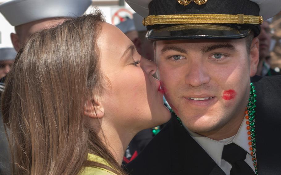 Ensign Jonathan Wheeler, assigned to the gold crew of the ballistic missile submarine USS Alaska (SSBN 732), receives a kiss during the Savannah St. Patrick's Day Parade on March 16, 2013. Ladies from the crowd traditionally run over to kiss uniformed men marching in the parade