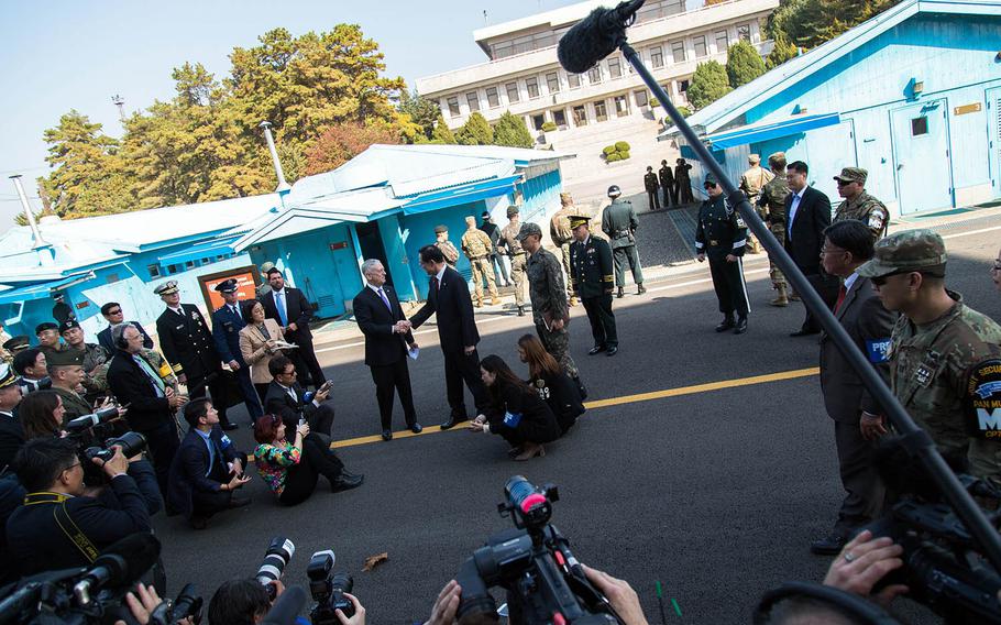 Secretary of Defense Jim Mattis greets South Korean Defense Minister Song Young-moo near the Military Demarcation Line at Panmunjom, South Korea, Friday, Oct. 27, 2017. 
