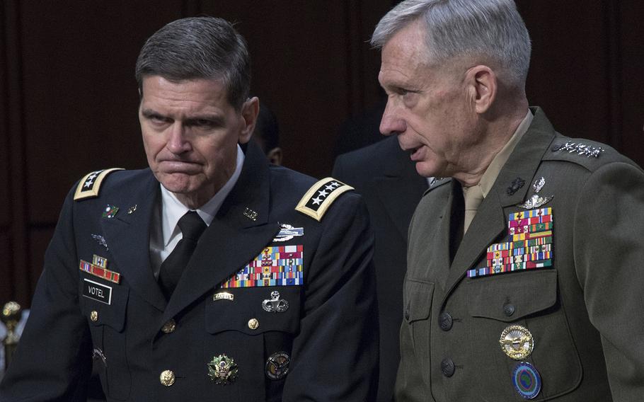 Gen. Joseph L. Votel, left, commander of the U.S. Central Command, talks with Gen. Thomas D. Waldhauser, commander of the U.S. Africa Command, before a Senate Armed Services Committee hearing on Capitol Hill, March 13, 2018.