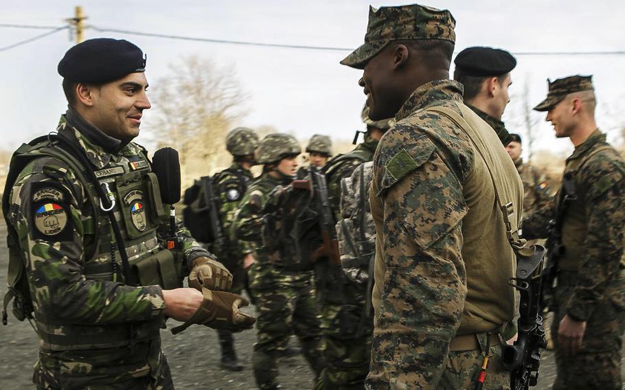 Members of the 26th Marine Expeditionary Unit meet with Romanian servicemembers on March 10, 2018 at the Capu Midia training area during the Spring Storm exercise. 
