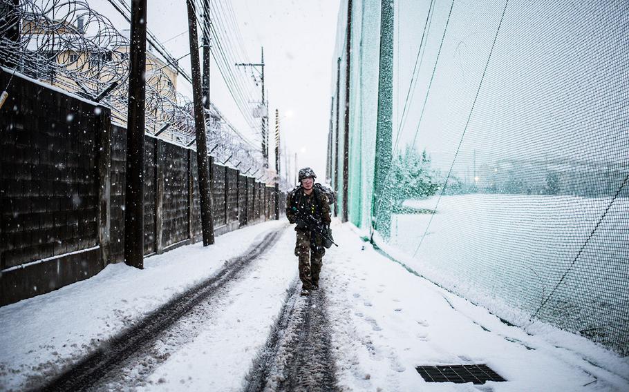 A 19th Expeditionary Sustainment Command best warrior competitor marches 12-miles through a freak snow storm at Camp Walker, South Korea on Thursday, March 8, 2018. 