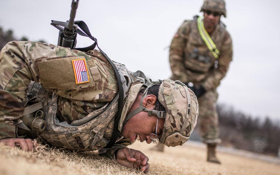 Sgt. William Stallworth, 176th Financial Management Support Unit, 19th Expeditionary Sustainment Command best warrior competitor low crawls during a stress shoot at Masan, South Korea on Wednesday, March ,7, 2018. 