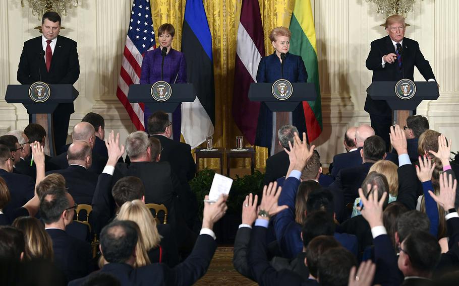 President Donald Trump, left, calls on a reporter as he is joined by, from left, Latvian President Raimonds Vejonis, Estonian President Kersti Kaljulaid, and Lithuanian President Dalia Grybauskaite, for a news conference in the East Room of the White House in Washington, Tuesday, April 3, 2018.