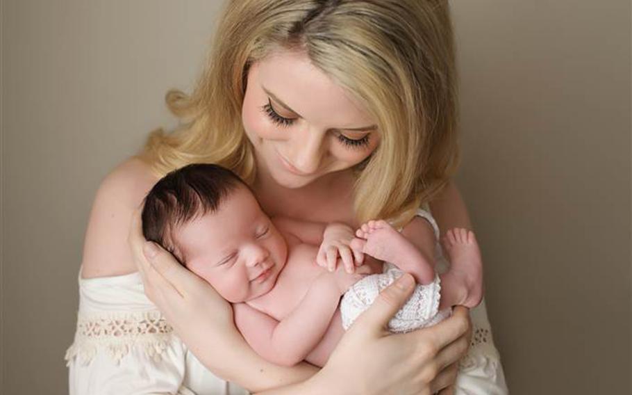  Brittany "Britt" Harris holds her daughter, Christian Michelle Harris.