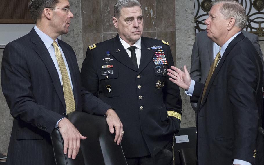 Secretary of the Army Mark Esper and Army Chief of Staff Gen. Mark Milley talk with Sen. Lindsey Graham, R-S.C., before a Senate Armed Services Committee hearing on Capitol Hill, April 12, 2018.