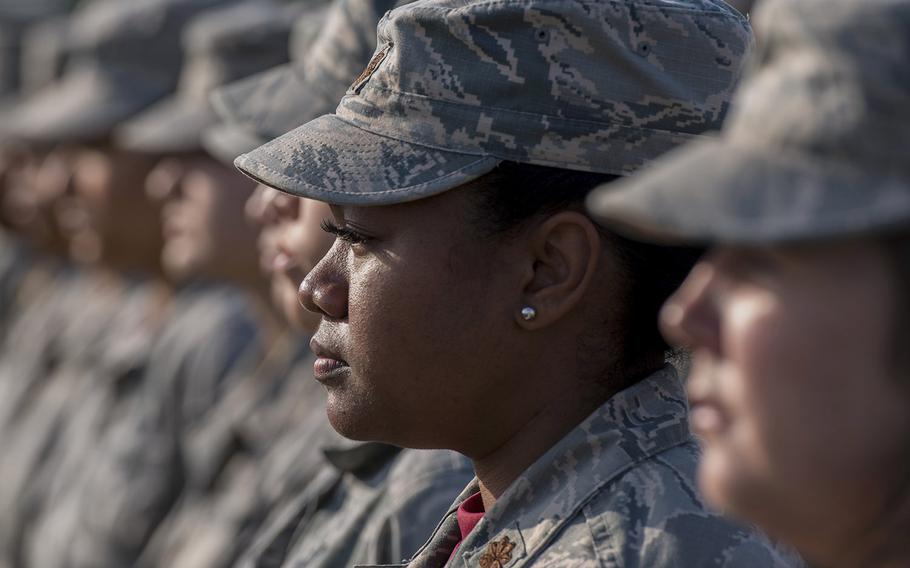 Airmen stand at attention during a retreat ceremony Mar. 30, 2018, on Kadena Air Base, Japan, where an all-female formation was coordinated in honor of Women's History Month.