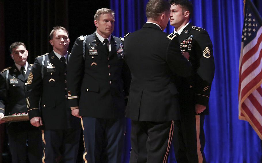 Army Lt. Gen. Austin S. Miller, the chief of Joint Special Operations Command, pins the Silver Star Medal on Staff Sgt. Michael Young on Friday. Young was honored for his actions as a Ranger weapons squad leader during a firefight in eastern Afghanistan in April 2017.