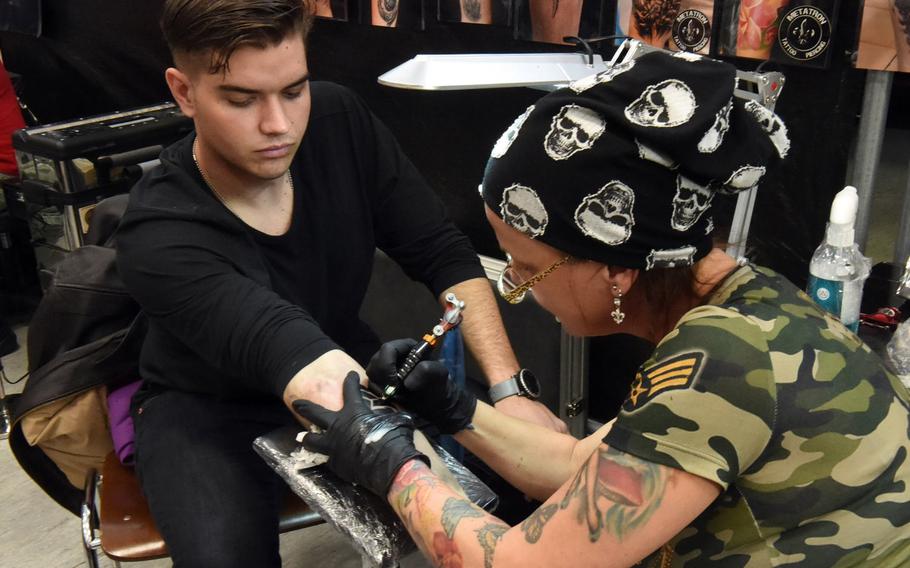 Pvt. Peter Bower, an infantry soldier with the 2nd Cavalry Regiment, gets an ancient Germanic symbol tattooed on his forearm at the Tattoo Expo Grafenwoehr, in Grafenwoehr, Germany, Sunday, April 15, 2018.