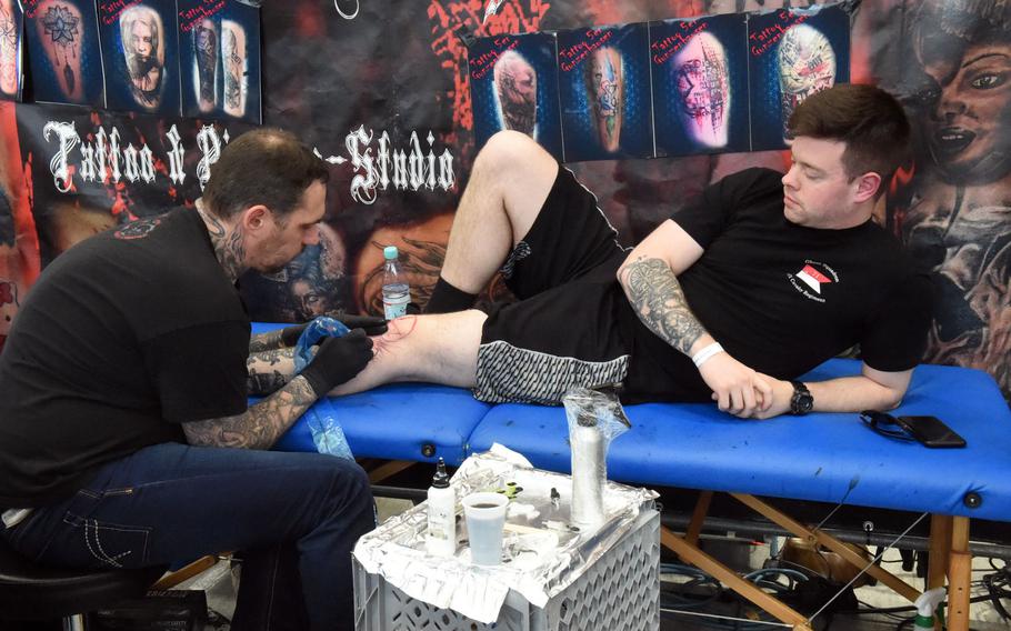 Sgt. Kevin Deerwester, an infantryman with the 2nd Cavalry Regiment, gets a skull tattooed on his knee at the Tattoo Expo Grafenwoehr, in Grafenwoehr, Germany, Sunday, April 15, 2018.