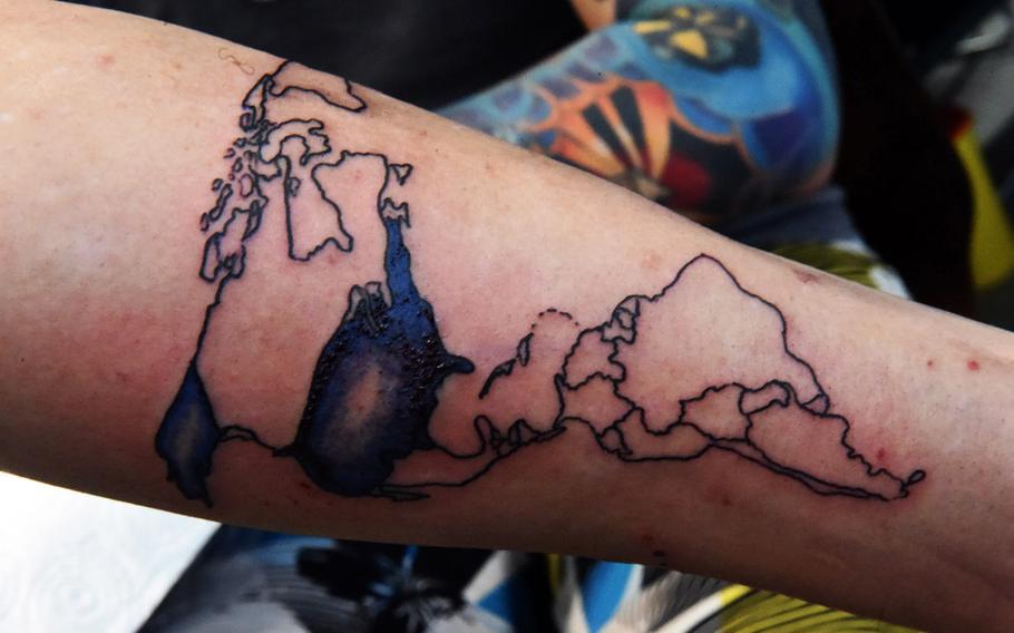 Spc. Marcus Sheppard, a military policeman at U.S. Army Garrison Bavaria, shows his in-progress tattoo of a map of the world, at the Tattoo Expo Grafenwoehr, in Grafenwoehr, Germany, Sunday, April 15, 2018. Taylor ended up winning best color tattoo.